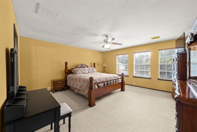 carpeted bedroom with a textured ceiling and ceiling fan