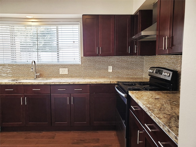 kitchen with stainless steel electric range oven, sink, exhaust hood, and dark hardwood / wood-style floors