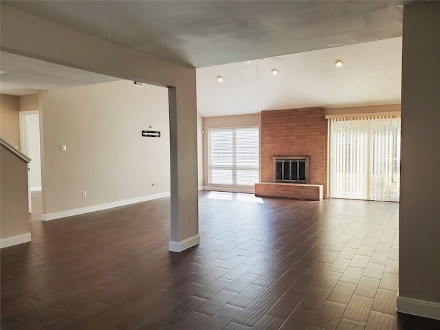 unfurnished living room with a fireplace and dark wood-type flooring