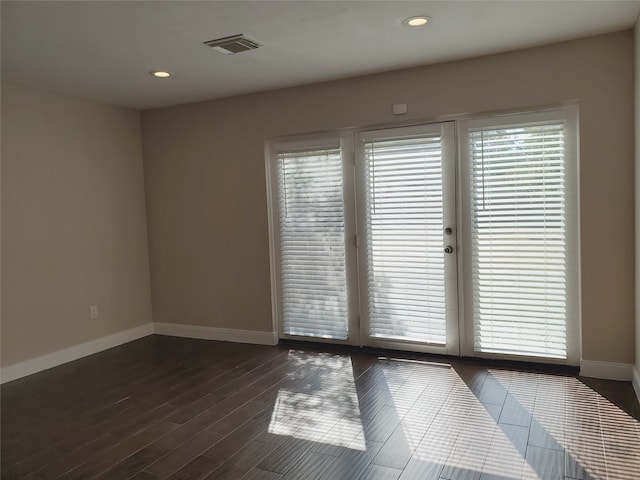 spare room with dark hardwood / wood-style flooring