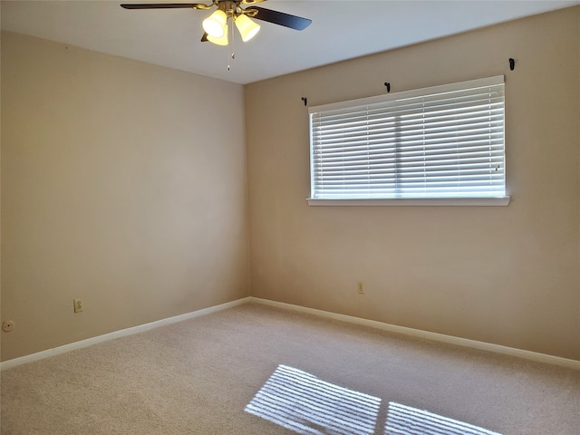 carpeted empty room featuring ceiling fan and a wealth of natural light