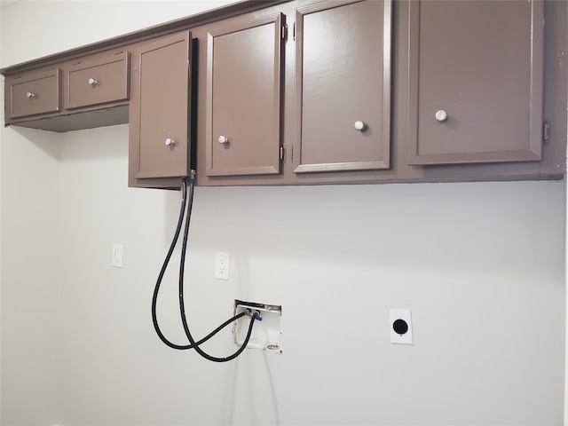 clothes washing area with washer hookup, hookup for an electric dryer, and cabinets