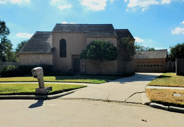 view of front of home with a garage and a front lawn