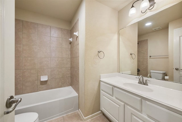 full bathroom with tile patterned floors, tiled shower / bath combo, toilet, and vanity