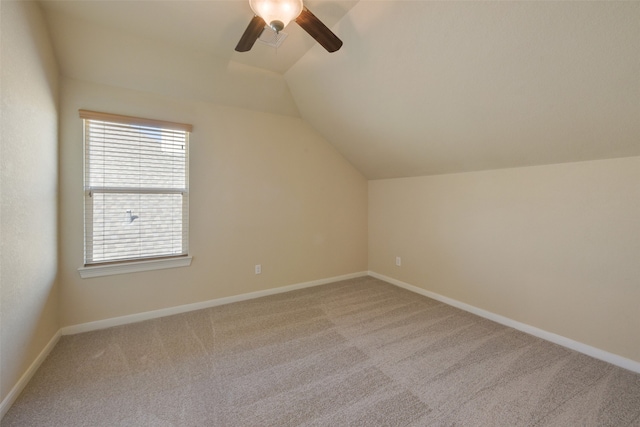 bonus room with light colored carpet, vaulted ceiling, and ceiling fan