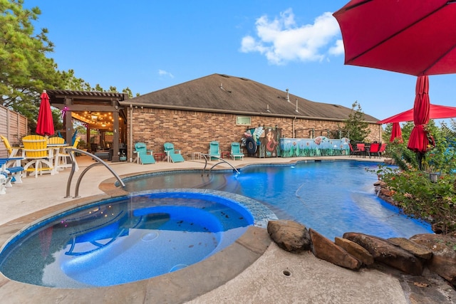 view of swimming pool featuring a patio area and an in ground hot tub