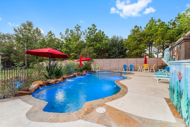 view of pool with pool water feature, an in ground hot tub, and a patio