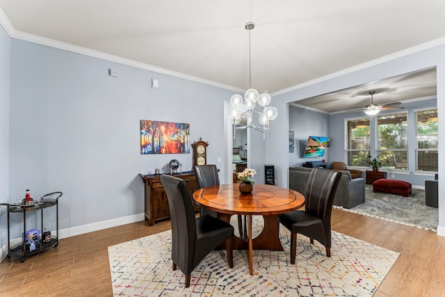 dining room featuring hardwood / wood-style floors, ceiling fan with notable chandelier, and ornamental molding