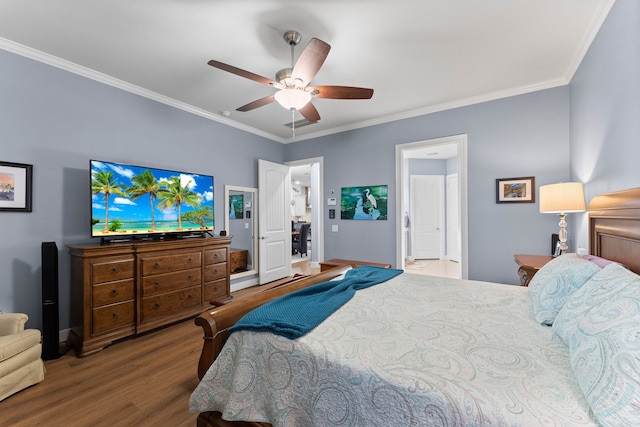 bedroom featuring wood-type flooring, ensuite bath, ceiling fan, and crown molding