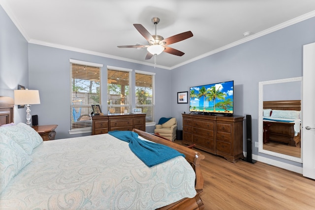 bedroom with light hardwood / wood-style floors, ceiling fan, and crown molding