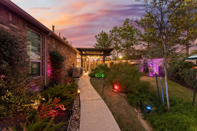 yard at dusk with a pergola