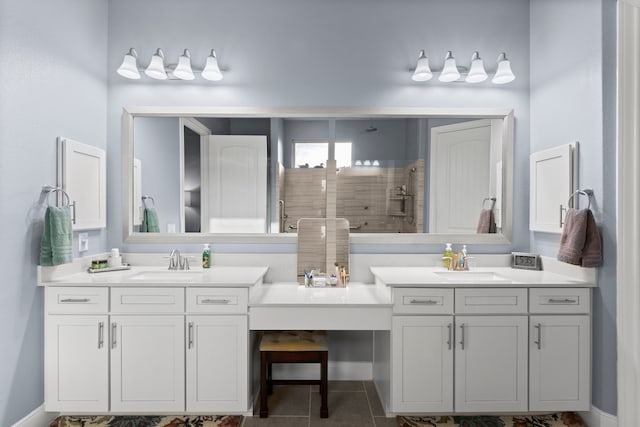 bathroom with tile patterned flooring, vanity, and a shower