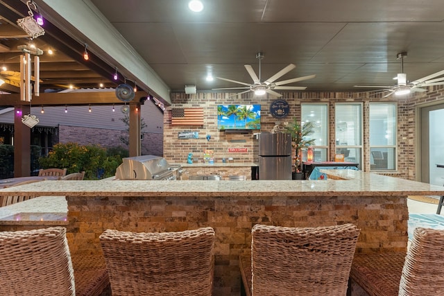 bar with stainless steel fridge and brick wall