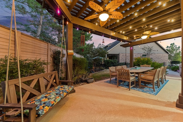 patio terrace at dusk featuring ceiling fan