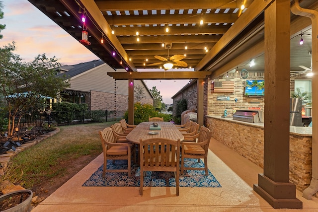 patio terrace at dusk with a grill and ceiling fan