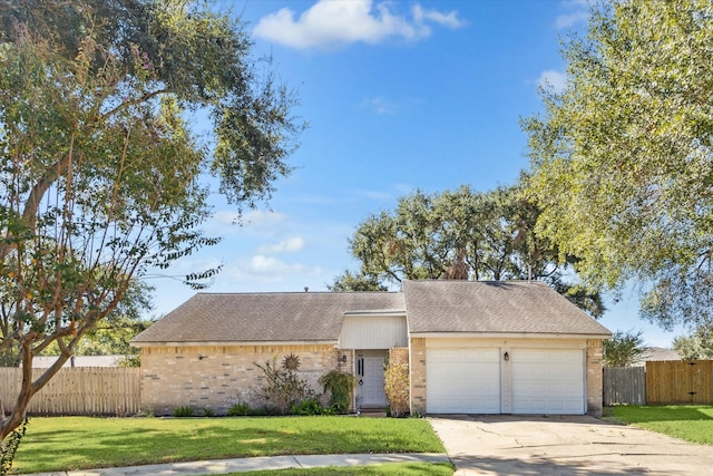 view of front of property with a front lawn and a garage