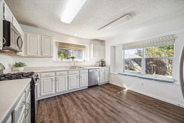 kitchen featuring white cabinetry, appliances with stainless steel finishes, and dark hardwood / wood-style floors