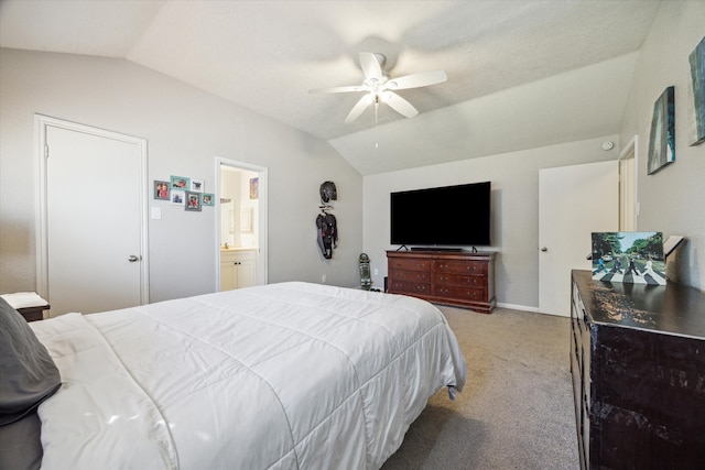 carpeted bedroom featuring lofted ceiling, ensuite bathroom, and ceiling fan