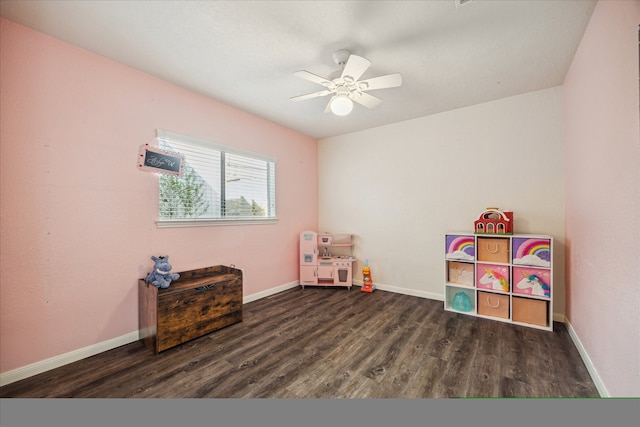 recreation room featuring dark hardwood / wood-style floors and ceiling fan