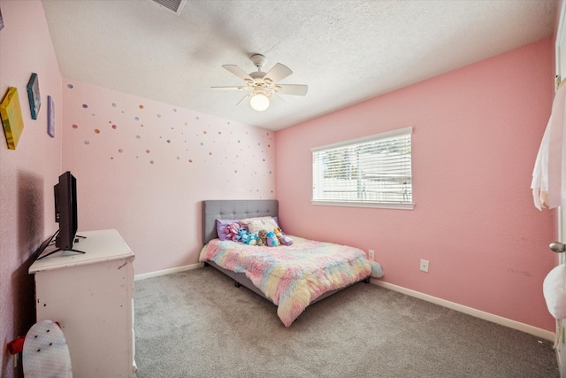 carpeted bedroom with a textured ceiling and ceiling fan