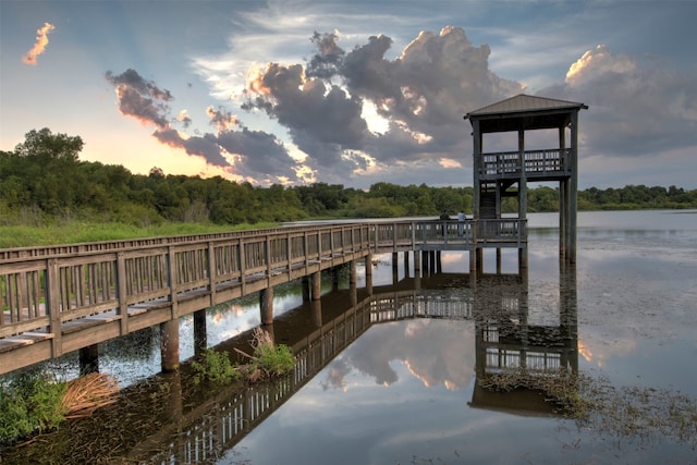 view of dock featuring a gazebo and a water view