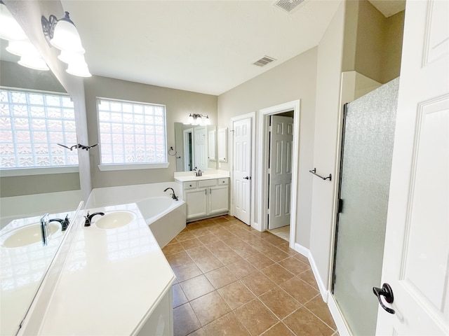 bathroom with vanity, independent shower and bath, and tile patterned flooring