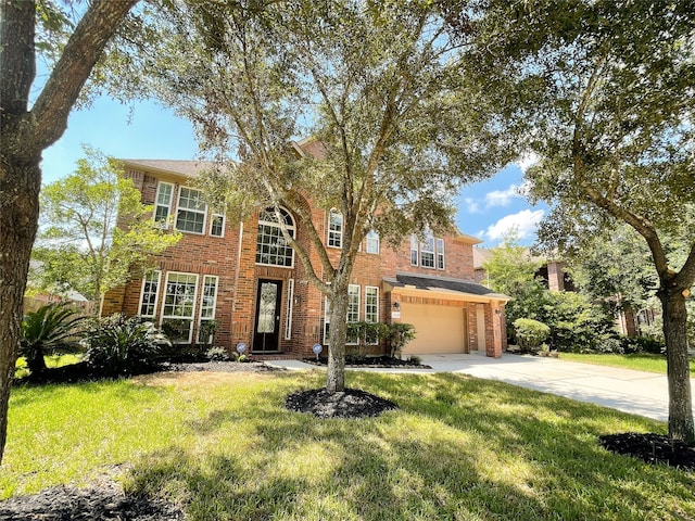 view of front of house featuring a front lawn and a garage