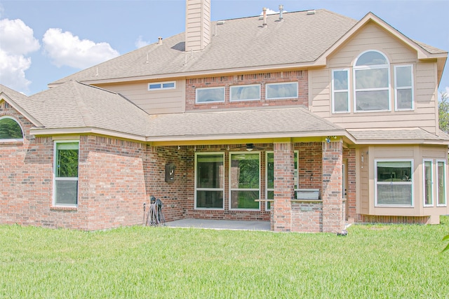 rear view of house featuring a yard