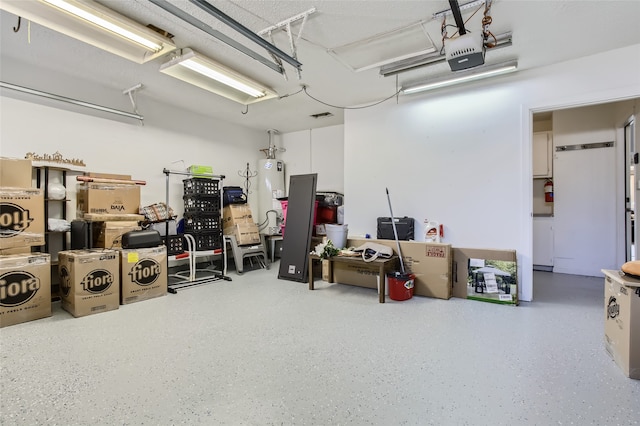 garage with a garage door opener and water heater