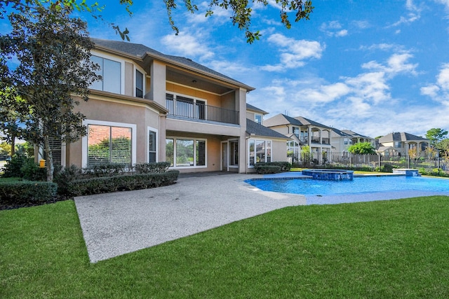 view of pool featuring a fenced backyard, a patio area, a lawn, a pool with connected hot tub, and a residential view