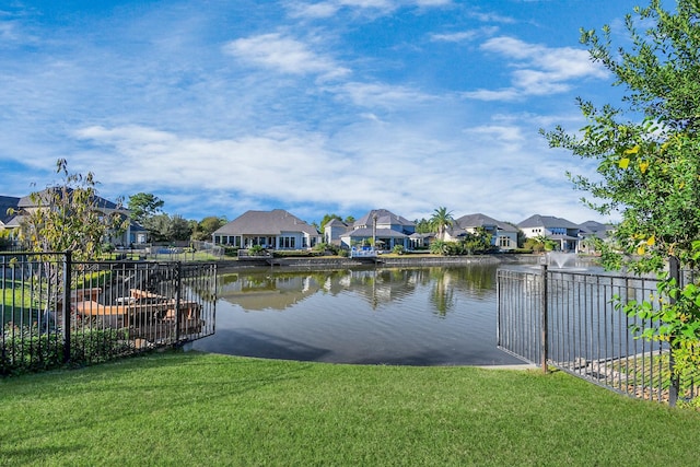 property view of water with fence and a residential view