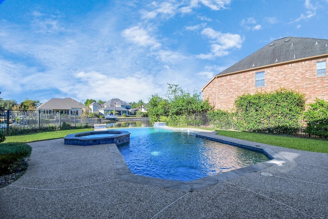view of pool with fence, a pool with connected hot tub, and a residential view