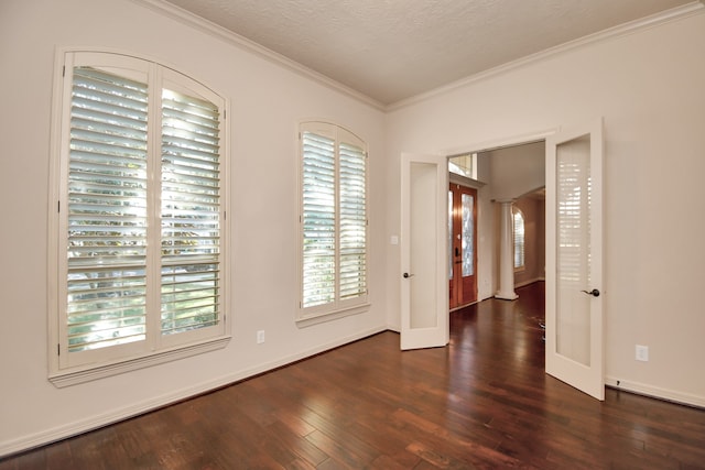 unfurnished room featuring ornamental molding, a textured ceiling, and dark hardwood / wood-style flooring