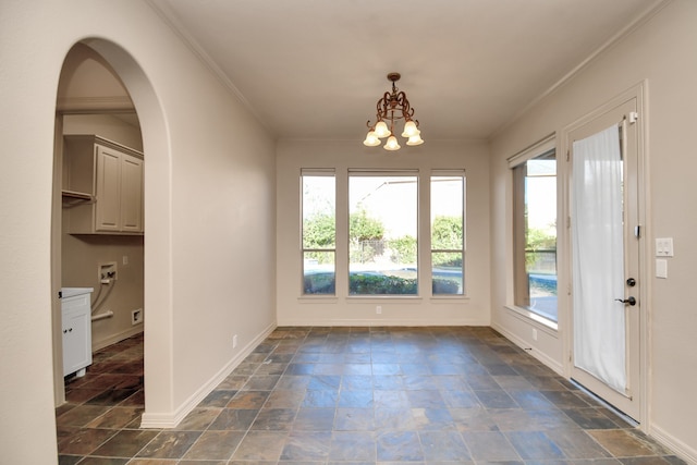 interior space featuring crown molding, a wealth of natural light, and a chandelier