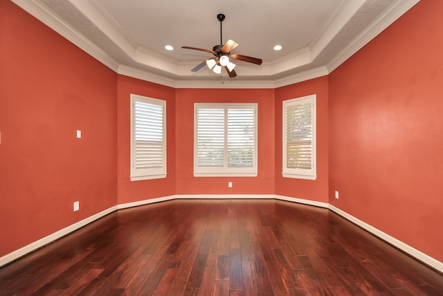 spare room featuring ceiling fan, a raised ceiling, ornamental molding, and wood-type flooring