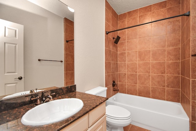 bathroom with toilet, a textured ceiling, tub / shower combination, and vanity