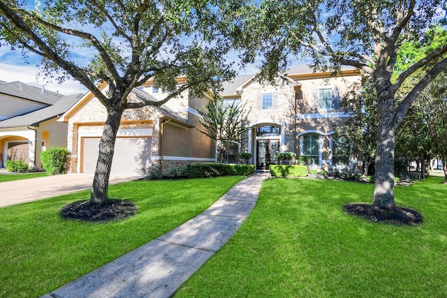 view of front of house with a garage, a front lawn, stone siding, and concrete driveway
