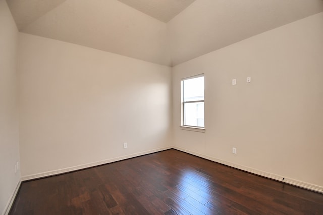 empty room with wood-type flooring and vaulted ceiling