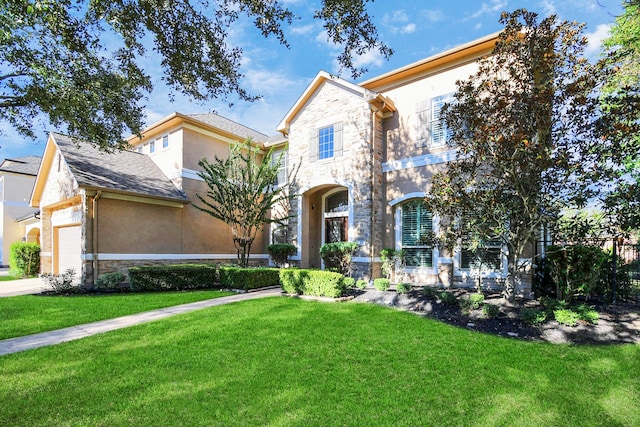 view of front of property with a front yard and a garage