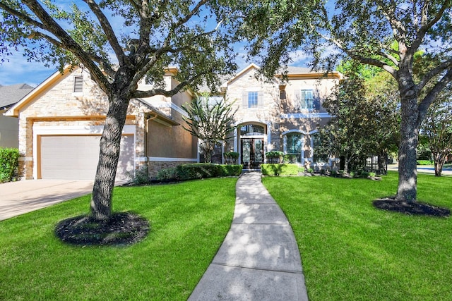 view of front of property featuring concrete driveway, a front yard, and stone siding