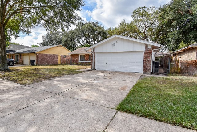 view of property exterior with a lawn and a garage