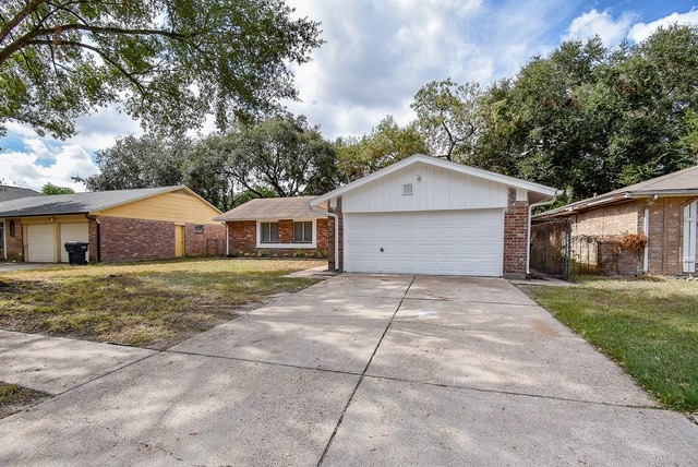 single story home with a front yard and a garage