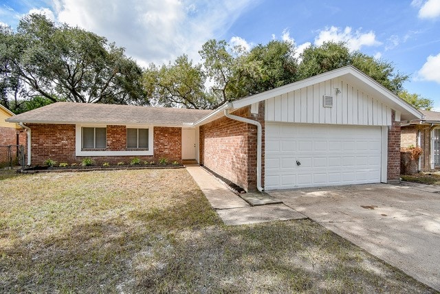 single story home with a front yard and a garage