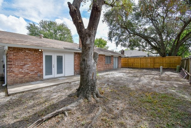 view of yard featuring french doors and a patio