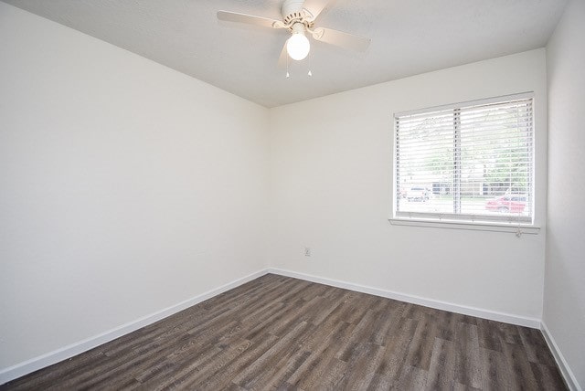 spare room featuring dark wood-type flooring and ceiling fan