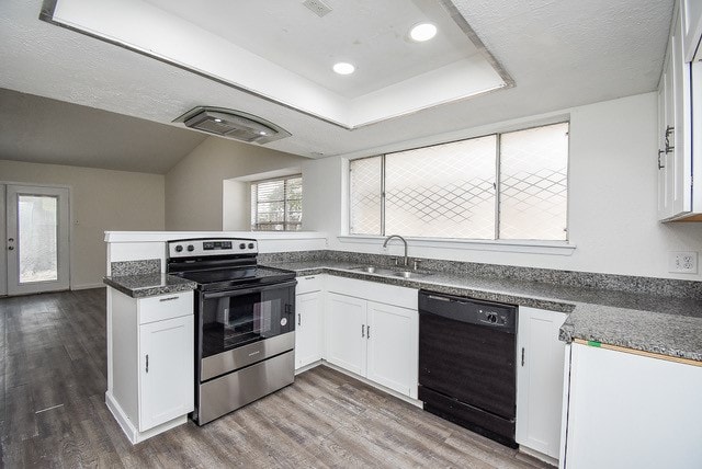 kitchen with black dishwasher, wood-type flooring, sink, stainless steel range with electric cooktop, and white cabinets