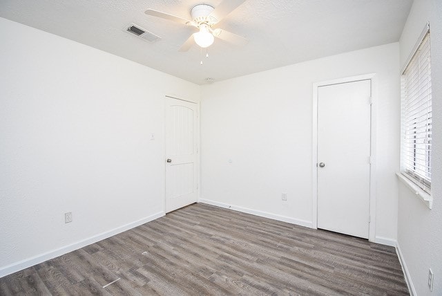 spare room featuring ceiling fan and hardwood / wood-style flooring