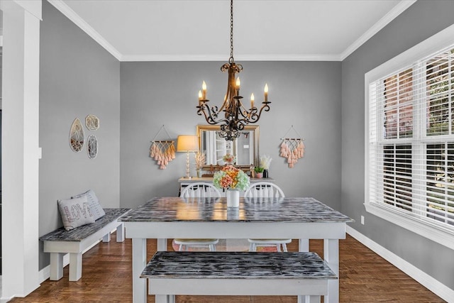 dining room featuring a notable chandelier, ornamental molding, and dark hardwood / wood-style floors