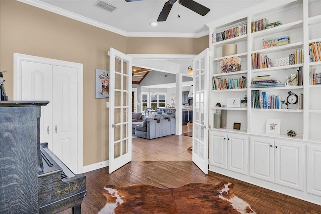 interior space with ornamental molding, french doors, dark hardwood / wood-style floors, and ceiling fan