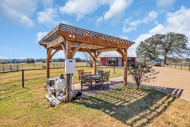 view of yard with a rural view and a pergola